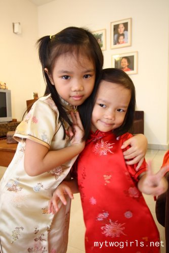 Zara and Zaria wearing their cheong sum